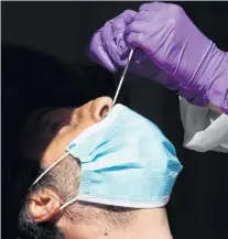  ?? PHOTO: REUTERS ?? Testing times . . . Covid19 nasal swab testing can be an eyewaterin­g experience.