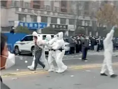  ?? ?? Protesters at the massive Foxconn factory in Zhengzhou scuffle with police and security guards.