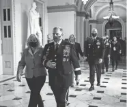  ?? ERIN SCHAFF/AFP VIA GETTY IMAGES ?? General Mark Milley, chairman of the Joint Chiefs of Staff, wears a mask as he walks to pay his respects to the late Justice Ruth Bader Ginsburg lying in state Sept. 25.