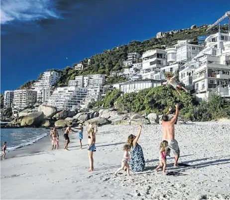  ?? Picture: DAVID HARRISON ?? UP IN THE AIR: Tourists and locals enjoy Clifton Beach in Cape Town. Buyers and investors at the top end are now very hesitant to transact