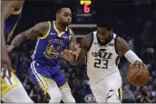  ?? BEN MARGOT — THE ASSOCIATED PRESS ?? Utah Jazz forward Royce O’Neale, right, drives the ball against the Warriors’ D’Angelo Russell in the first half on Wednesday in San Francisco.