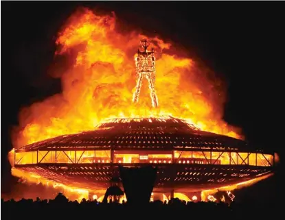  ?? ANDY BARRON / THE RENO GAZETTE- JOURNAL VIA AP ?? The “Man” burns at the Burning Man festival near Gerlach, Nevada, on Aug. 31, 2013.