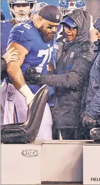  ?? AP ?? HELPING HAND: Ronnie Barnes, who has been with the Giants since 1976 and became the first African-American head trainer in the NFL in 1980, helps an injured Jon Halapio last season.