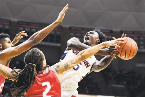  ?? Stephen Dunn / Associated Press ?? UConn’s Sidney Wilson, right, attempts to shoot in the first half against Sacred Heart Friday in Storrs.