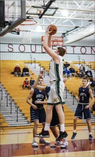  ?? JAMES BEAVER/FOR DIGITAL FIRST MEDIA ?? Lansdale Catholic sophomore Hunter Healy grabs a big rebound early in the game against Council Rock North on Saturday.