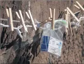  ??  ?? Toothpaste hangs from a clothespin on The Giving Wall in Newburgh on Monday afternoon.