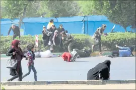  ?? MEHDI PEDRAMKHOO — THE ASSOCIATED PRESS/MEHR NEWS AGENCY ?? Civilians try to take cover during a shooting in Iran at a military parade marking the start of Iran’s 1980s war with Iraq. At least 25 people died in the shooting and 60 were wounded.