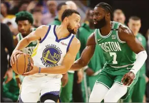  ?? Ezra Shaw / Getty Images ?? The Celtics’ Jaylen Brown, right, guards the Warriors’ Stephen Curry in Game 2 of the NBA Finals on June 5.