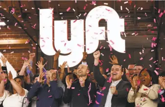  ?? Mario Tama / Getty Images ?? Lyft executives celebrate in March as the company begins trading on the Nasdaq in March.