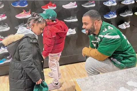  ?? Dennis Waszak Jr./Associated Press ?? New York Jets defensive lineman Solomon Thomas chats with a student from Brooklyn Community Services Jets’ Academy during a holiday shopping spree hosted by the team at Dick’s Sporting Goods in East Hanover, N.J., on Tuesday.