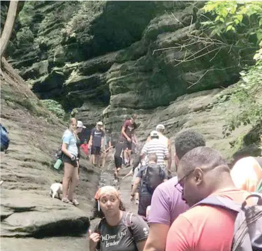  ?? PROVIDED PHOTOS ?? Christine Meissner, in the orange headband, leads a group into the French Canyon of Starved Rock State Park in June 2019.