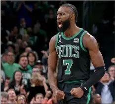  ?? STUART CAHILL — BOSTON HERALD ?? Boston Celtics star Jaylen Brown screams after sinking a 3-pointer as the Celtics defeated the Timberwolv­es earlier this season. Brown is enjoying a career season and headed to the All-star game.