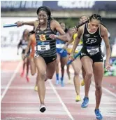  ?? COLLIN ANDREW/AP ?? USC’s Kendall Ellis, left, crosses the finish line to win the women's 1,600 relay and the national title for the Trojans on Saturday. The former St. Thomas Aquinas star came from way back in the final 100 meters to edge Purdue’s Jaheya Mitchel, right.