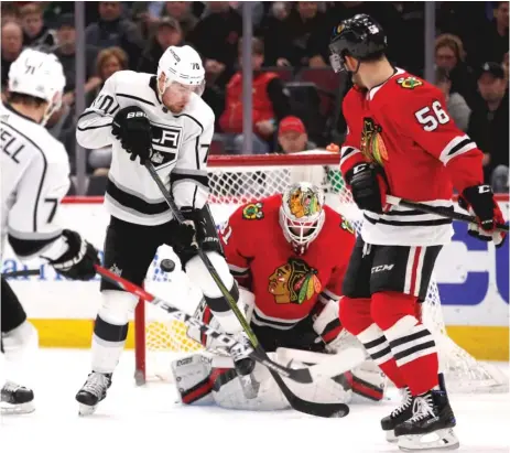  ??  ?? Kings left wing Tanner Pearson ( 70) tries to redirect the puck past Blackhawks goaltender Anton Forsberg in the first period.