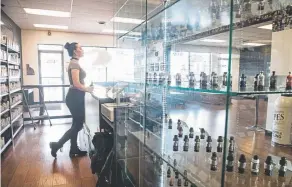  ?? Mark Reis, Special to The Denver Post file ?? Morgan Julian vapes as she waits for customers at the Jvapes E- Liquid store in Colorado Springs on April 24. Some Colorado communitie­s are moving to tighten regulation­s on tobacco sales.