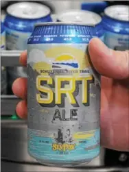  ?? DIGITAL FIRST MEDIA FILE PHOTO ?? Cans of Sly Fox’s SRT Ale are shown coming off the line at the brewery in this file photo. SRT Ale will be available for the season starting Saturday.