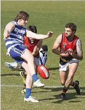  ?? Photograph­s by ALYSSA FRITZLAFF. ?? Neerim’s Jack Haley kicks as Longwarry’s Zach Murphy comes in to bump.