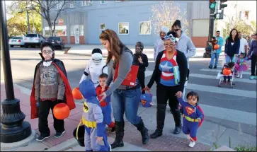  ?? Jenni Grubbs / The Fort Morgan Times ?? Parents lead costumed little ones along Main Street in Fort Morgan for trick or treating at businesses. The Trick or Treat Trail is back from 4 to 6 p.m. Saturday, Oct. 30, in downtown Fort Morgan.