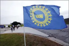  ?? PAUL SANCYA — THE ASSOCIATED PRESS FILE ?? File- In this file photo a UAW flag flies near strikers outside the General Motors Orion Assembly plant in Orion Township, Mich.