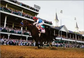  ?? Jeff Roberson / Associated Press ?? John Velazquez rides Medina Spirit across the finish line to win the 2021 Kentucky Derby at Churchill Downs in Louisville, Ky.