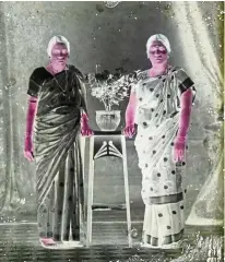  ??  ?? A glass plate negative featuring two women dressed in their beautifull­y embroidere­d sarees.