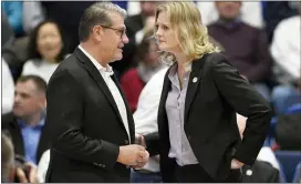  ?? JESSICA HILL — THE ASSOCIATED PRESS ?? Connecticu­t head coach Geno Auriemma, left, talks with Tennessee head coach Kellie Harper before Thursday’s game in Hartford, Conn.