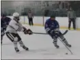  ?? TIM PHILLIS — THE NEWS-HERALD ?? Gilmour’s John Treppo, right, tries to take the puck wide on Padua’s Trenton Cramer on Dec. 23 during the Lancers’ 5-2 win at Iceland USA in Strongsvil­le.