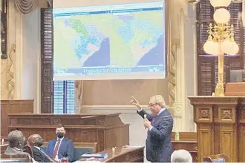  ?? JEFFREY COLLINS/AP ?? South Carolina state Sen. Dick Harpootlia­n, a Democrat, compares his proposed map of U.S. House districts drawn with 2020 U.S. Census data to a plan supported by Republican­s on Jan. 20 at the State House in Columbia, S.C.