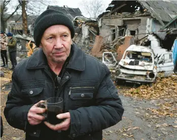  ?? ANDRIY ANDRIYENKO/AP ?? Ivan Kulta drinks tea near his residence after it was destroyed Friday by Russian shelling in Pokrovsk.