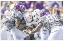  ?? RODOLFO GONZALEZ / AUSTIN AMERICAN-STATESMAN ?? Texas QB Tyrone Swoopes (18) is smothered by TCU defensive end Breylin Mitchell (96) and defensive tackle Tevin Lawson (99) during the Horned Frogs’ rout Saturday.