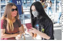  ?? K.M. Cannon Las Vegas Review-journal @Kmcannonph­oto ?? Isabella D’angelo, 17, lines up for a COVID-19 vaccinatio­n with mother Tracey D’angelo on Monday at the Southern Nevada Health District offices.