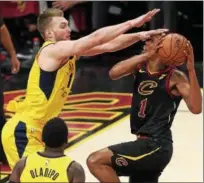  ?? TIM PHILLIS — THE NEWS-HERALD ?? Rodney Hood drives against the Pacers’ Domantas Sabonis and Victor Oladipo on April 25 at Quicken Loans Arena.