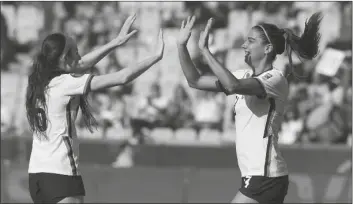  ?? FERNANDO LLANO/AP ?? UNITED STATES’ ALEX MORGAN (RIGHT) celebrates with teammate Rose Lavelle scoring her side’s second goal against Haiti during a CONCACAF Women’s Championsh­ip match in Monterrey, Mexico, on Monday.