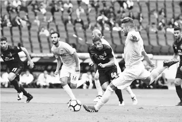  ??  ?? Lazio’s forward from Italy Ciro Immobile (R) scores a penalty during the Italian Serie A football match Lazio vs AC Milan on September 10, 2017 at the Olympic stadium in Rome. - AFP photo