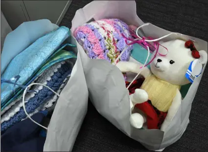  ?? ?? Staff members at Alternativ­es Pregnancy Center have bags filled with donated baby items to give to their pregnant clients.