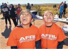  ?? JIM THOMPSON/JOURNAL ?? Aaliyah Valencia, left, and Katrina Chavez of San Felipe Pueblo watch a rocket take off during the Air Force Research Laboratory STEM Academy’s rocket launch Tuesday in Rio Rancho.