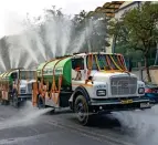  ?? PTI ?? GOVERNMENT DRIVE: Tankers spray water to curb air pollution in New Delhi. —