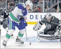  ?? AP PHOTO ?? Vancouver Canucks forward Bo Horvat and Los Angeles Kings goalie Darcy Kuemper battle in the third period of an NHL pre-season game in Los Angeles on Saturday.