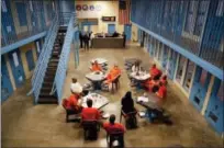  ?? JULIE JACOBSON — THE ASSOCIATED PRESS ?? Inmates inside Albany County jail’s veteran’s pod gather for a group session with Sarah Polidore, center, executive director of field services for Moral Reconation Therapy on Nov. 27, 2017, in Albany, N.Y. Albany County’s jail devotes one of its...