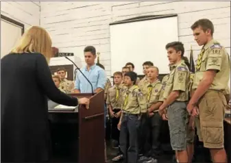  ?? LAURA QUAIN — DIGITAL FIRST MEDIA ?? Above, Patrick Eigenbrod, head lifeguard (middle), is joined by Boy Scout Troop 101 while Kutztown Mayor Sandy Green, left, recognizes him during the September Kutztown Borough Council meeting. Eigenbrod was honored for his actions that saved a boy at...