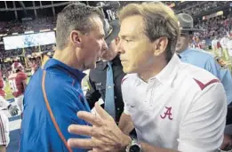  ?? DAVE MARTIN/ASSOCIATED PRESS ?? Urban Meyer, left, chose to find different employment rather than compete with Nick Saban in the SEC. The ex-Gators coach made the call himself, unusual for Saban’s foes.