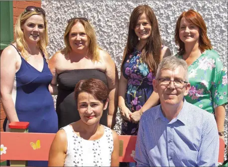  ??  ?? Pádraig and Eileen Cronin, in front, photograph­ed with the school’s staff members at the new Buddy Bench.