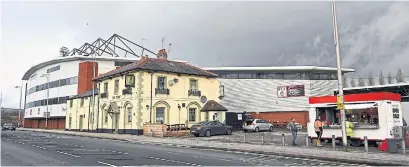  ??  ?? The Racecourse Ground stadium, the home field of Wrexham FC, is next to The Turf pub, the favoured watering hole for fans. Wrexham plays in the fifth-tier of English football, far removed from the glamour and worldwide reach of the elite Premier League.