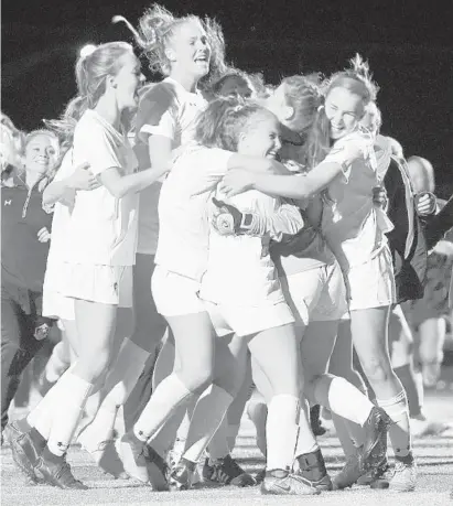  ?? BRIAN KRISTA/BALTIMORE SUN MEDIA GROUP ?? The Severna Park girls soccer team celebrates its win over South River during the Anne Arundel County championsh­ip game at Chesapeake High on Tuesday night. After two halves and two overtime periods of scoreless play, the Falcons (14-1) emerged victorious on penalty kicks. Madeline Altman, Kailyn McCulloch, Chase Campbell and Toni Fiocco-Mizer all scored in the shootout for Severna Park.