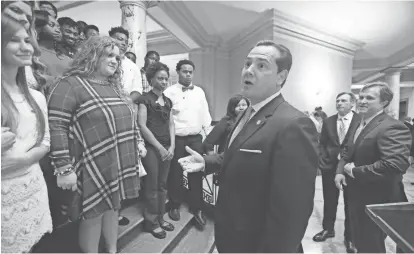  ?? ROGELIO V. SOLIS/AP ?? Delta Regional Authority federal co-chairman Christophe­r Masingill, center, expresses his pride in the efforts of students in the Jobs for Mississipp­i Graduates program April 1, 2016, at the Capitol in Jackson, Miss. The Delta Regional Authority would...