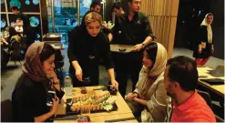  ??  ?? Iranians are served at a high-end French sushi chain.