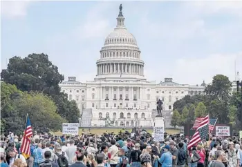  ?? KENNY HOLSTON/THE NEW YORK TIMES ?? Far-right demonstrat­ors and journalist­s gather Saturday near the Capitol in Washington, during the “Justice for J6” rally. The crowd was sparse and incidents were few.