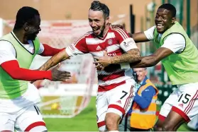  ??  ?? SMILES BETTER: a delighted Dougie Imrie (centre) celebrates his winning goal