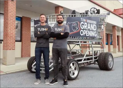  ?? PHOTOS COURTESY TURN5 ?? Turn5 co-founders Steve and Andrew Voudouris stand with the Shopper Chopper, a 10-foot-tall, street-legal shopping cart that was onsite and decked-out with Turn5 Grand Opening graphics Jan. 10. Turn5 has relocated and expanded its Pottstown location — moving into a building at 80 Robinson St.