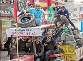  ?? SAID KHATIB/AFP ?? Palestinia­n men drive a trailer loaded with tyres in Rafah, in the southern Gaza Strip, on Thursday.